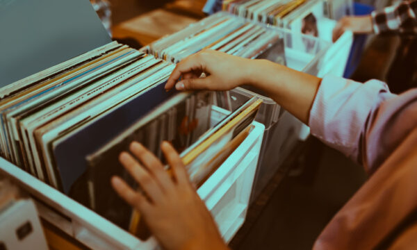 Woman is choosing a vinyl record in a musical store Woman is choosing a vinyl record in a musical store